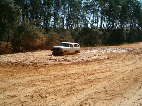 1991 Ford Bronco - This 1991 Ford Bronco is navigating a challenging muddy off-road path.