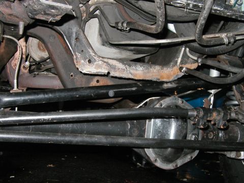 1994 Ford Bronco - The photo shows the undercarriage of a vehicle, focusing on the suspension and steering components.