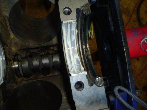 1981 Ford Bronco - Close-up of an engine block showing the crankshaft, bearing caps, and assembly lube during a build.
