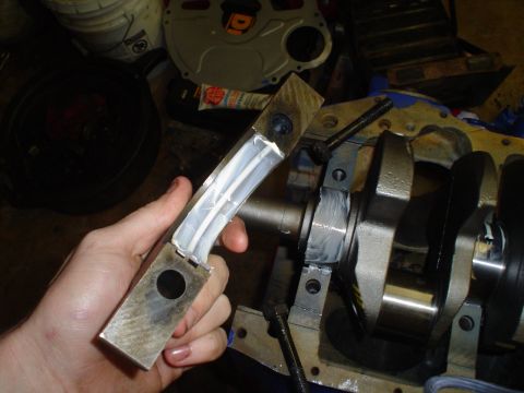 1981 Ford Bronco - Installing bearing caps onto an engine crankshaft.
