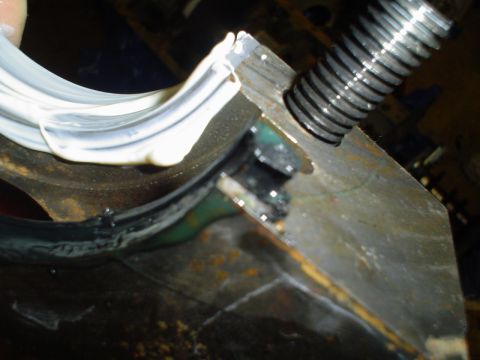 1981 Ford Bronco - Applying sealant to an engine bearing during a build or repair process.