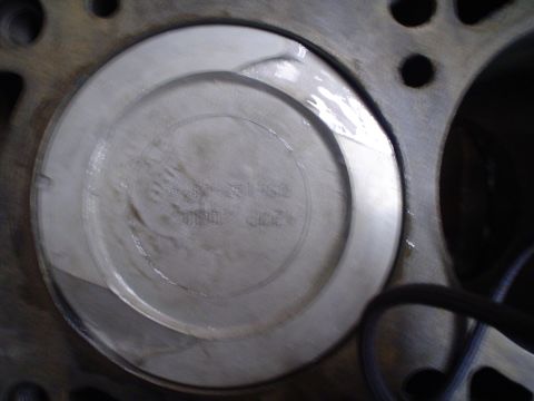 1981 Ford Bronco - Close-up view of a piston within an engine block, showing some inscribed text.