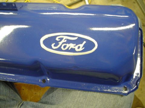 1981 Ford Bronco - A blue Ford valve cover with a white oval emblem is shown in a close-up view.