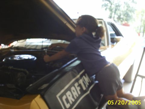 1973 Ford Ranchero - 7-year old wrenching on a new front shock. Bringing her up right!