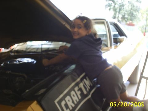 1973 Ford Ranchero - 7-year old daughter wrenching away on a front shock. Bringing her up right!