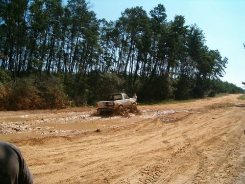 1991 Ford Bronco - 1991 Ford Bronco navigating a challenging muddy trail.