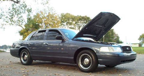 1998 Ford Crown Victoria - This Ford Crown Victoria, likely from the early 2000s, is shown with its hood raised on a cool, overcast day.