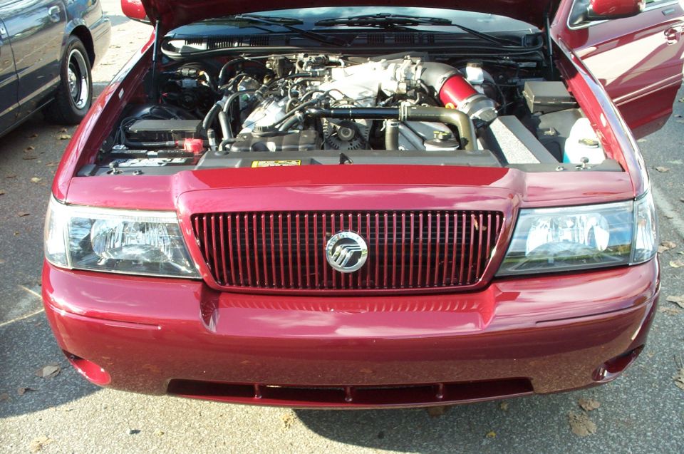 Maroon Mercury sedan, hood up showing a modified engine bay with red intake.