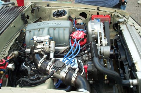 1998 Ford Crown Victoria - Custom engine bay with a prominent supercharger and MSD ignition components.