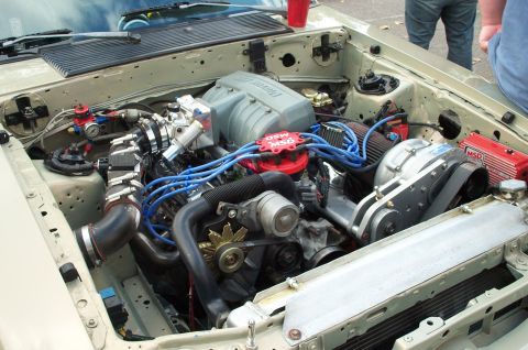 1998 Ford Crown Victoria - Custom engine bay a prominent supercharger and MSD ignition system, likely modified for performance.