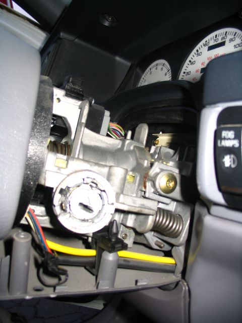 1993 Ford Taurus - Close-up view of the ignition switch assembly and dashboard instruments within a vehicle's interior.