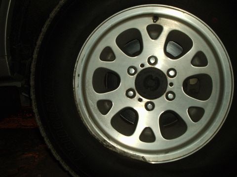 2000 Ford Taurus - A close-up view of a vehicle's wheel and tire, with website text visible in the lower right corner.