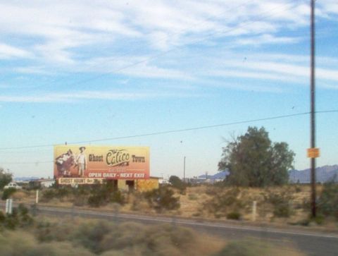 1988 Ford Bronco - Billboard advertising Ghost Calico Town, with text indicating it is open daily and the next exit.