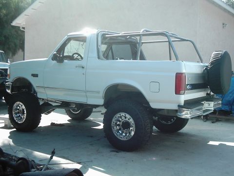 1978 Ford Bronco - This lifted Ford Bronco features a custom roll cage and off-road tires, suggesting it's built for terrain.