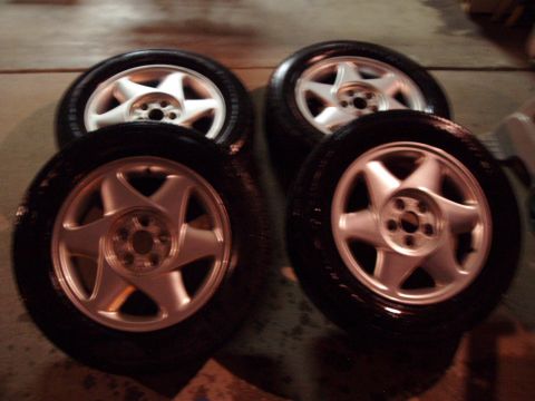 1993 Ford Taurus - Set of four alloy wheels and tires, likely for a sedan or coupe.