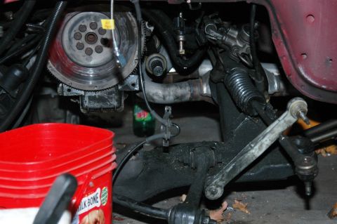 1991 Ford Taurus - Engine bay detail showing flywheel, exhaust, and steering components.