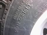 1986 Ford Bronco - Close-up of a tire sidewall showing size and warning text.