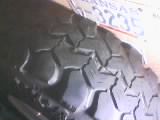 1986 Ford Bronco - A close-up of a spare tire's tread pattern is visible, along with a portion of a Kansas license plate.