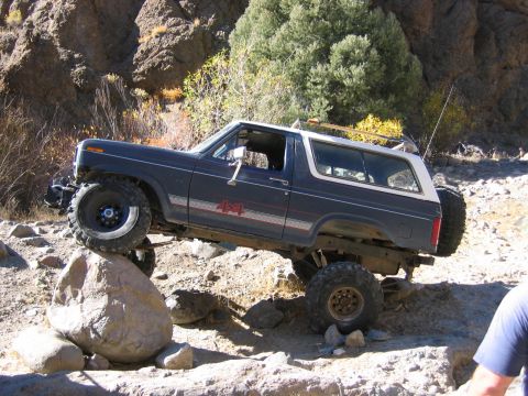1986 Ford Bronco - Modified 1986 Ford Bronco navigating a challenging off-road obstacle course.