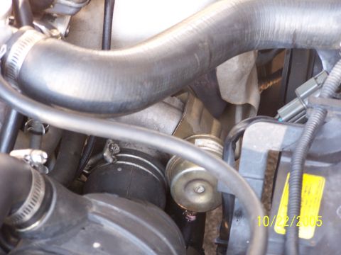 1997 Mitsubishi Eclipse - Close-up view of an engine bay, showing various components and hoses, with a date stamp indicating it was taken in 2005.