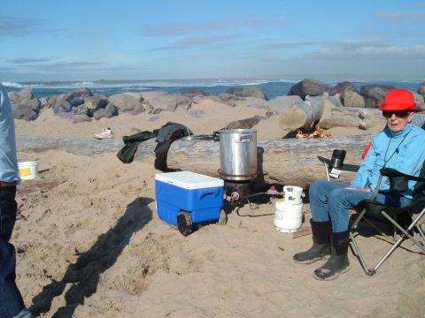 2000 Ford F-250 - People are cooking on the beach with a cooler and propane tank nearby.