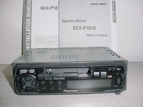 1991 Ford Crown Victoria LTD - Pioneer KEH-P1010 car stereo and its manuals are displayed on a surface.