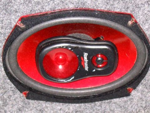 1991 Ford Crown Victoria LTD - A car speaker with a red cone and a black tweeter is visible, with the brand name 'Roadmaster' on the tweeter.