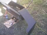 1986 Ford Bronco - Aftermarket winch plate bumper assembly is shown on wooden blocks.