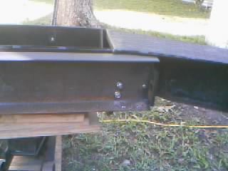 1986 Ford Bronco - Close-up view of a black metal winch plate bumper, showing its construction and attachment points.