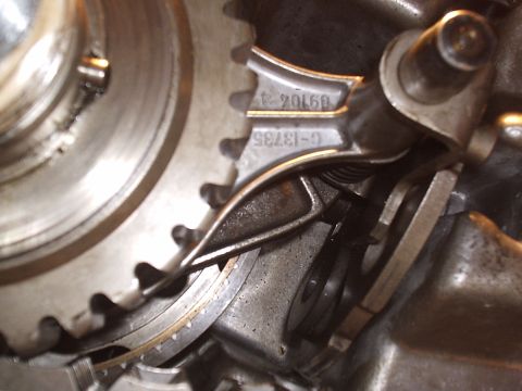 1985 Ford Bronco - Tight macro of the internals of a disassembled manual transmission, showing a splined gear and its shift-collar teeth beside a forged deten…