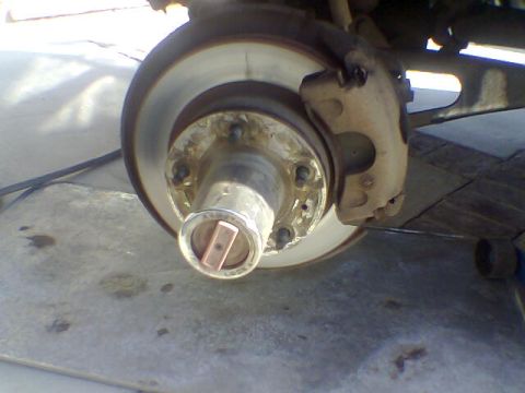 1988 Ford Bronco - Close-up of a vehicle's wheel hub and brake assembly, showing a locking mechanism.