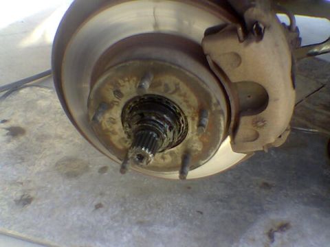 1988 Ford Bronco - Front wheel hub and brake assembly, likely undergoing maintenance or repair.