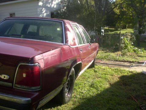 1991 Ford LTD Crown Victoria - This maroon sedan's body style suggests a 1990 model year, not a 1991 Ford Crown Victoria LTD.