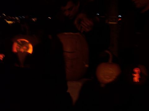 2001 Ford Crown Victoria - Carved pumpkins displayed outdoors at night, with some showing illuminated faces.