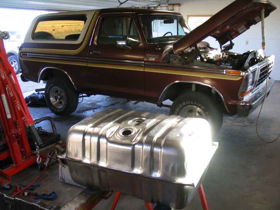 Brown 1978 Ford Bronco with hood open, fuel tank in foreground