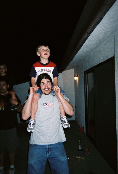 1990 Ford Bronco - A father gives his son a piggyback ride to watch fireworks on the Fourth of July.
