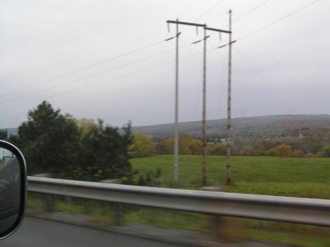 1997 Subaru Impreza - A view from a vehicle shows power lines and a rural landscape under an overcast sky.