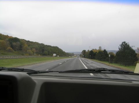 1997 Subaru Impreza - Driving on a highway with trees lining the side and other vehicles ahead.