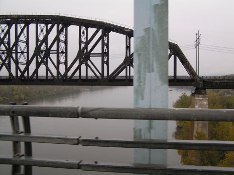 1997 Subaru Impreza - View of a large railroad bridge spanning a river, taken from a passing vehicle.