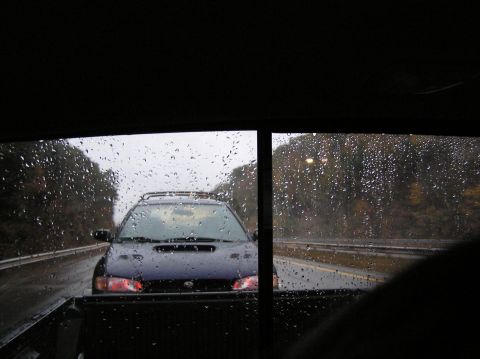1997 Subaru Impreza - Driving on a rainy highway, following a dark blue Subaru Impreza.