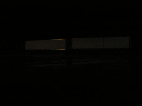 1997 Subaru Impreza - Two semi-trailers are parked in darkness at night, with minimal lighting.