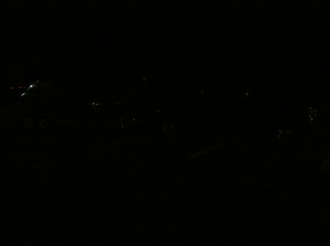 1997 Subaru Impreza - A car is barely visible in the dark, with only its wheels and headlights faintly illuminated.