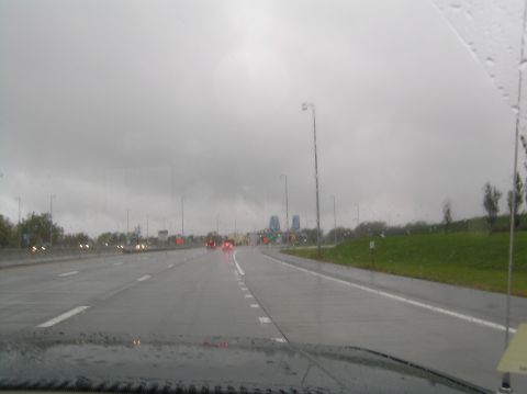 1997 Subaru Impreza - View from inside a vehicle on a wet highway under a cloudy sky.