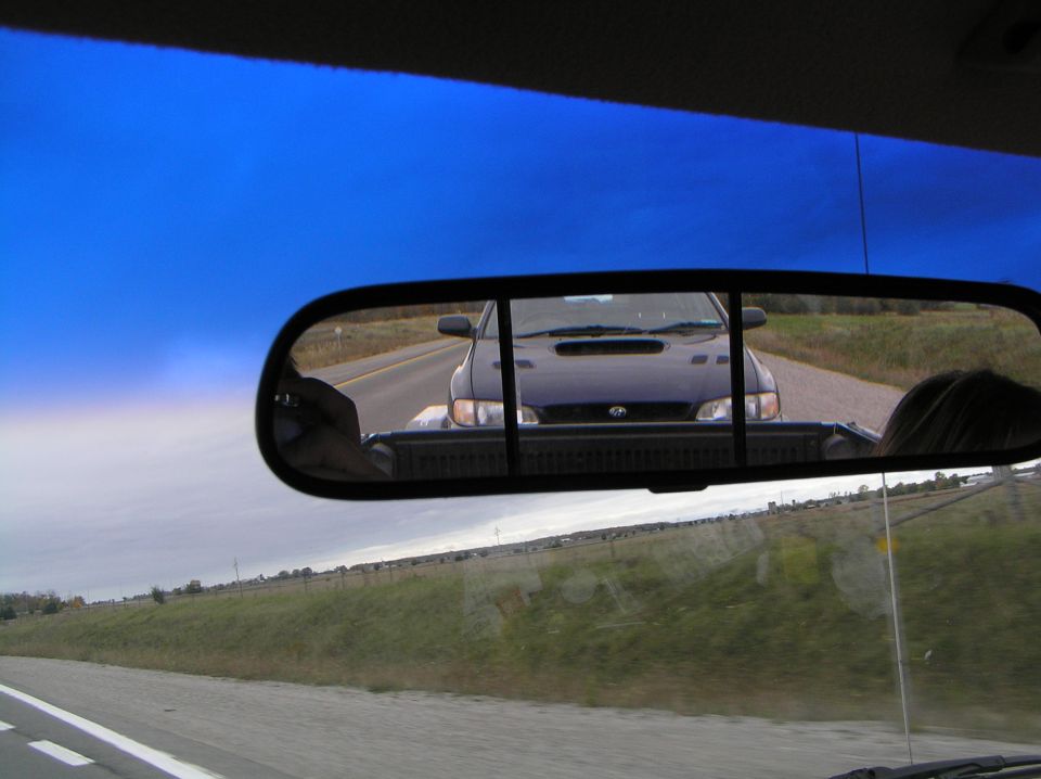 Dark blue 1997 Subaru Impreza WRX seen in rearview mirror