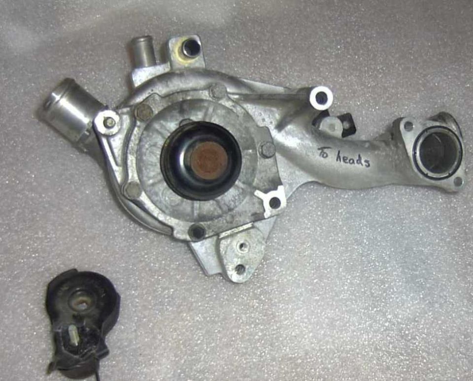 Water pump with handwritten "to heads" label