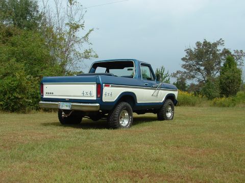 1979 Ford Bronco - This 1979 Ford Bronco features a two-tone blue and white paint scheme and prominent 4x4 badging on the rear quarter panels.