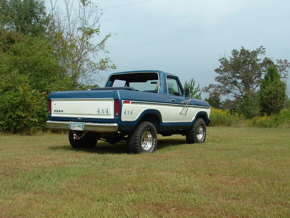Rear view of a blue and white 1979 Ford Bronco with 4x4 badging