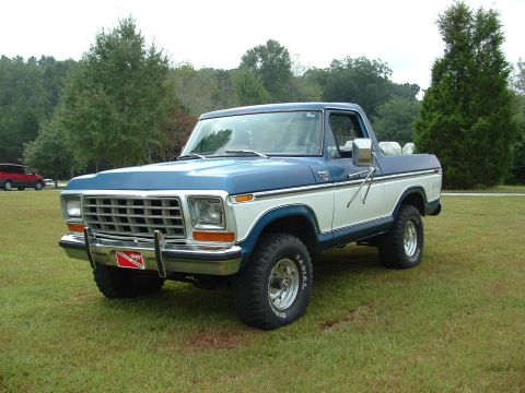 1979 Ford Bronco - This 1979 Ford F-Series pickup truck is shown from the front 3/4 angle on a grassy field.