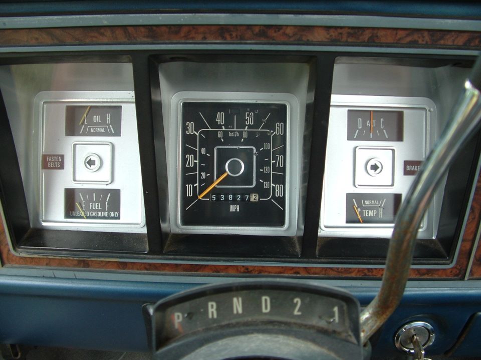 Dashboard with speedometer, fuel gauge, oil pressure gauge, temperature gauge, and gear selector