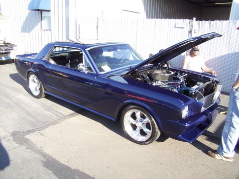 2002 Ford Mustang - Customized 1965 Ford Mustang coupe with aftermarket wheels and engine modifications.